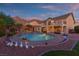 Beautiful backyard oasis with a large pool, spa, lush landscaping, and mountain views at 6958 Lazy Sunset Ct, Las Vegas, NV 89156