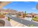 Elevated view of homes featuring mature landscaping and mountain views in the distance at 6958 Lazy Sunset Ct, Las Vegas, NV 89156