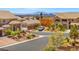 Street view of upscale homes with well-maintained landscaping and mountain views at 6958 Lazy Sunset Ct, Las Vegas, NV 89156