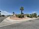 Street view of a well-kept home on a corner lot featuring desert landscaping and mature palm trees at 7104 Carrondale Way, Las Vegas, NV 89128