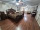 Spacious main bedroom boasting a decorative bed frame, ceiling fan, and hardwood floors at 7104 Carrondale Way, Las Vegas, NV 89128