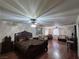 Open-concept main bedroom with hardwood floors, seating area, and ceiling fans at 7104 Carrondale Way, Las Vegas, NV 89128