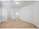 Spacious bedroom with wood-look laminate flooring and white trim, showing access to the closet at 7775 Tyrell Peaks St, Las Vegas, NV 89139