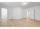 Large bedroom with wood-look laminate flooring, white trim, and white doors leading to other rooms at 7775 Tyrell Peaks St, Las Vegas, NV 89139