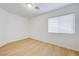 Cozy bedroom with a window, wood-look laminate flooring, and neutral walls at 7775 Tyrell Peaks St, Las Vegas, NV 89139
