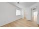 Well-lit bedroom featuring wood-look laminate flooring and closet access at 7775 Tyrell Peaks St, Las Vegas, NV 89139