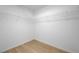 Walk-in closet with white wire shelving and wood-look laminate flooring at 7775 Tyrell Peaks St, Las Vegas, NV 89139