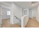 Bright upstairs hallway with light wood floors, and an opening to a bedroom at 7775 Tyrell Peaks St, Las Vegas, NV 89139