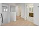 Upstairs hallway with white walls, light wood floors, and doors leading to various rooms at 7775 Tyrell Peaks St, Las Vegas, NV 89139