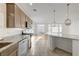 Open kitchen layout features granite counters, stainless appliances and access to living area at 7775 Tyrell Peaks St, Las Vegas, NV 89139