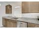 Modern kitchen area featuring granite countertops, stainless steel dishwasher and sink at 7775 Tyrell Peaks St, Las Vegas, NV 89139