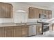 Well-lit kitchen boasts granite countertops, stainless steel appliances, and wood cabinetry at 7775 Tyrell Peaks St, Las Vegas, NV 89139