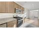 Contemporary kitchen with stainless appliances, granite countertops, and an open layout at 7775 Tyrell Peaks St, Las Vegas, NV 89139