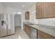 Modern kitchen with stainless steel appliances, granite countertops, and wood cabinets at 7775 Tyrell Peaks St, Las Vegas, NV 89139