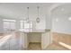 Spacious kitchen with granite island and bright living space, great for entertaining guests at 7775 Tyrell Peaks St, Las Vegas, NV 89139