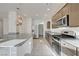 Modern kitchen with stainless steel appliances, granite countertops, and a large center island at 7775 Tyrell Peaks St, Las Vegas, NV 89139