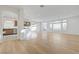 Open-concept living room features bright white walls, natural light, and beautiful wood floors at 7775 Tyrell Peaks St, Las Vegas, NV 89139