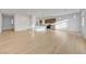 Spacious living room area featuring lovely hardwood floors, white walls, and access to the kitchen at 7775 Tyrell Peaks St, Las Vegas, NV 89139