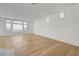 Bright and open living room with hardwood flooring and ample natural light from large windows at 7775 Tyrell Peaks St, Las Vegas, NV 89139