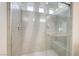 Modern shower with gray tile, glass enclosure, and a built-in bench at 7775 Tyrell Peaks St, Las Vegas, NV 89139