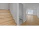 Bright entryway featuring a wooden staircase leading to the upper level and an adjacent half bathroom at 7775 Tyrell Peaks St, Las Vegas, NV 89139