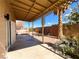 View of covered patio area and low-maintenance backyard with rock landscaping at 8125 Rio De Janeiro Dr, Las Vegas, NV 89128