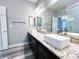 This bathroom features a marble countertop with dual white vessel sinks and a large mirror at 8125 Rio De Janeiro Dr, Las Vegas, NV 89128