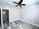 Bedroom with wood-look floors, ceiling fan, and doorway to the upstairs hallway at 8125 Rio De Janeiro Dr, Las Vegas, NV 89128