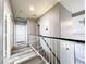 Upstairs hallway featuring a staircase, gray paint and wood-style flooring leading to closets at 8125 Rio De Janeiro Dr, Las Vegas, NV 89128