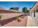 Low-maintenance backyard with gravel, plants, and covered patio for outdoor enjoyment at 825 Royal Moon Ave, Las Vegas, NV 89123