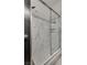 Walk in shower with marble tile and glass door at 825 Royal Moon Ave, Las Vegas, NV 89123