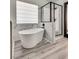 Modern bathroom featuring a freestanding tub, marble accents, and glass shower at 825 Royal Moon Ave, Las Vegas, NV 89123