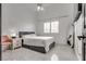 Bright bedroom featuring a ceiling fan, window with shutters, and a modern grey bed frame at 825 Royal Moon Ave, Las Vegas, NV 89123