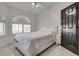 Airy bedroom with white bed, arched windows, and white tile floors at 825 Royal Moon Ave, Las Vegas, NV 89123