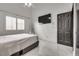 This bright bedroom is complete with a ceiling fan, mounted TV, window with shutters at 825 Royal Moon Ave, Las Vegas, NV 89123