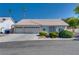 Charming single-story home featuring a three-car garage and desert landscaping at 825 Royal Moon Ave, Las Vegas, NV 89123