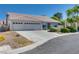 Single-story house with a spacious driveway and desert landscaping at 825 Royal Moon Ave, Las Vegas, NV 89123