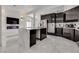 Modern kitchen with a waterfall island, sleek black cabinets and stainless steel appliances at 825 Royal Moon Ave, Las Vegas, NV 89123