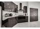 Sleek black cabinetry, modern appliances, and stylish countertops create an elegant kitchen at 825 Royal Moon Ave, Las Vegas, NV 89123