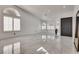Bright living room featuring large windows and a shiny tile floor at 825 Royal Moon Ave, Las Vegas, NV 89123