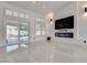 Modern living room featuring a fireplace, TV, and sliding glass doors at 825 Royal Moon Ave, Las Vegas, NV 89123