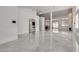 Open-concept living area with tile flooring and large windows at 825 Royal Moon Ave, Las Vegas, NV 89123