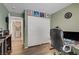 Cozy bedroom with light green walls, hardwood floors, a closet, and a workstation at 8656 Rowland Bluff Ave, Las Vegas, NV 89178