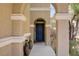 Inviting front entrance featuring a secure door, desert landscaping and a covered porch at 8656 Rowland Bluff Ave, Las Vegas, NV 89178