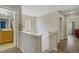 Bright hallway showcasing hardwood floors, neutral walls, and access to a bathroom and bedroom at 8656 Rowland Bluff Ave, Las Vegas, NV 89178