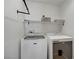 This laundry room features a Maytag washer and dryer, a hanging bar, and a shelf at 8656 Rowland Bluff Ave, Las Vegas, NV 89178