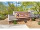Exploration Peak Park sign featuring lush landscaping and stone base in a community park at 8656 Rowland Bluff Ave, Las Vegas, NV 89178