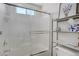 Bright shower showcasing a sliding glass door, built-in seat, and a mounted caddy at 8656 Rowland Bluff Ave, Las Vegas, NV 89178