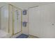 Bright shower showcasing a sliding glass door, a built-in seat, and a mounted caddy at 8656 Rowland Bluff Ave, Las Vegas, NV 89178