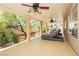 Relaxing covered patio boasts stylish lounge chairs, ceiling fans, and views of the well-maintained backyard at 8875 Tidal Bay Dr, Las Vegas, NV 89117